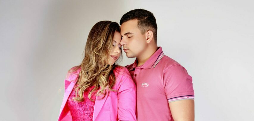 foto de casal apaixonado vestido de rosa com fundo cinza